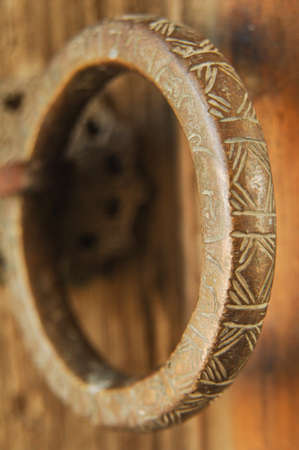 close-up antique vintage brass ring with an engraving on the door. blurred backgroundの写真素材