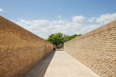 The road with brick walls on both sides. the ancient buildings of medieval Asiaの写真素材
