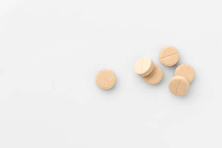 Many light beige medical tablets on a white background. The view from the top. Isolatedの写真素材