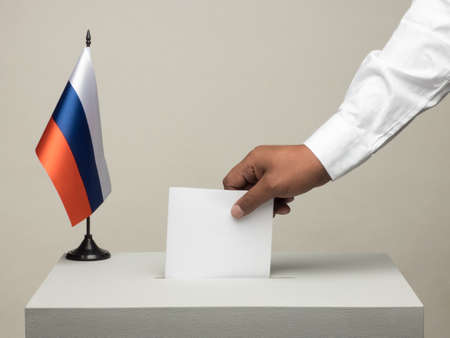 Ballot box with national flag of Russia. Presidential election in 2018. hand throwing a ballotの写真素材