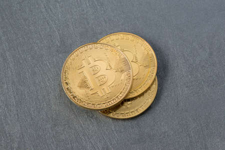 several bitcoins on a plastered surface, top view. electronic moneyの写真素材