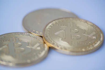 several gold bitcoin closeup, blurred photo. electronic money