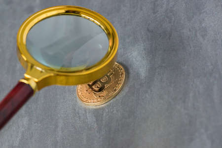 Viewing and the increase in bitcoin through a magnifying glass. electronic moneyの写真素材