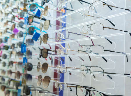 a variety of medical and sunglasses on the stand in the storeの写真素材