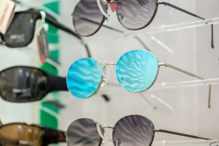 a variety of medical and sunglasses on the stand in the store
