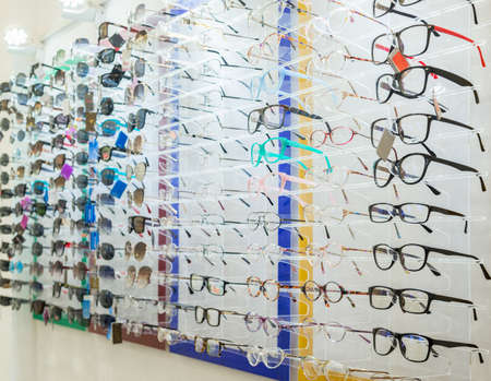 a variety of medical and sunglasses on the stand in the store