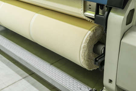 weaving loom at a textile factory, closeup. industrial fabric production line