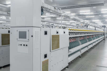 Machinery and equipment in the workshop for the production of thread. interior of industrial textile...