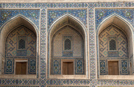 The arch and the exterior design of the ancient Registan in Samarkand. Ancient architecture of Central Asiaの写真素材