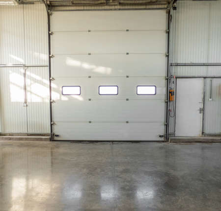 large closed gate with windows in the factory. front view
