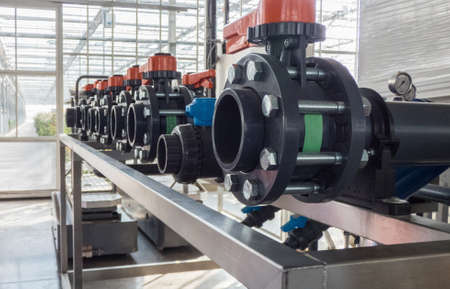 close-up of in a row of plastic pipes and water pumps