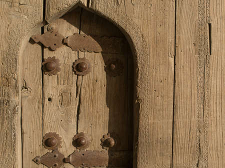 Old wooden door with metal rivets in Bukhara, Central Asia.の写真素材