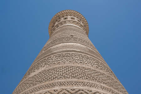 High oval tower of bricks, ancient Asian buildings. the details of the architecture of medieval Central Asiaの写真素材