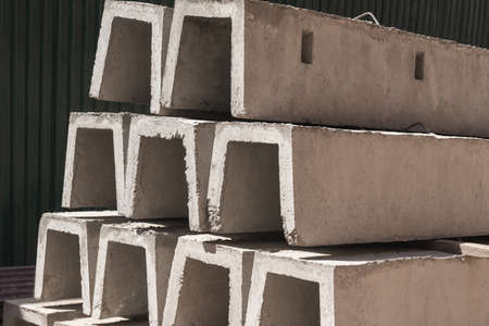 New concrete blocks for drainage, stacked in a row. Building material