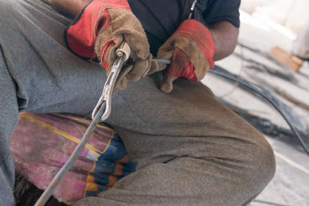 construction worker hands straightens the metal rod.の写真素材