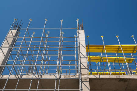 metal concrete structures of the building under construction. scaffolding and supports. bottom viewの写真素材