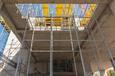 metal concrete structures of the building under construction. scaffolding and supports. bottom view