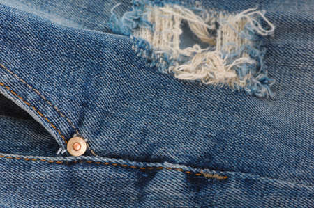 part of the blue denim pants with pockets and rivets, close-upの写真素材