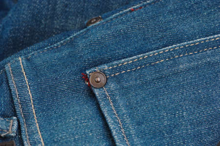 part of the blue denim pants with pockets and rivets, close-up