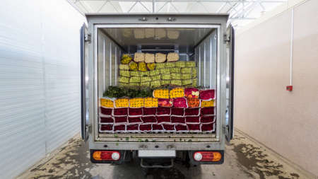 Opened back doors of the truck loaded with rose flowers. Loading flowers in stock for delivery.の写真素材
