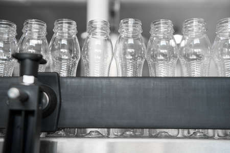 empty plastic bottles on conveyor belt. equipment at the dairy plant