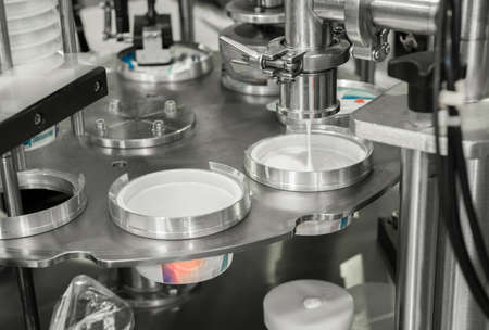 production and bottling of yogurt in plastic cups. equipment at the dairy plant