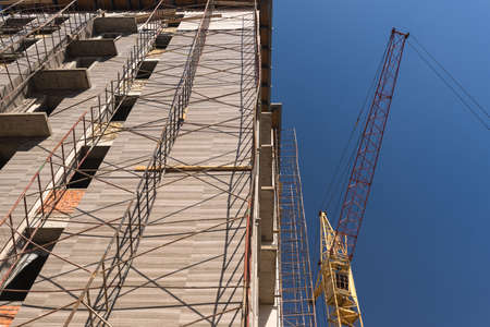 crane on the background of the building under construction