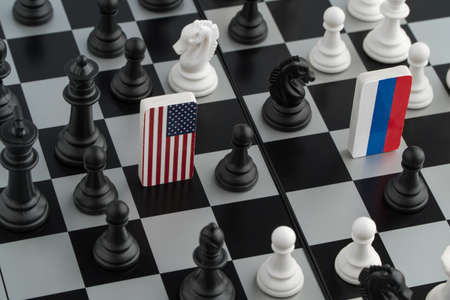 Symbols flag of Russia and the United States on the chessboard. The concept of political game.