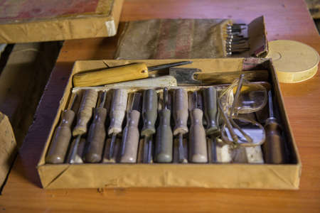 equipment in the workshop for the restoration of ancient musical instruments. wood carving tool
