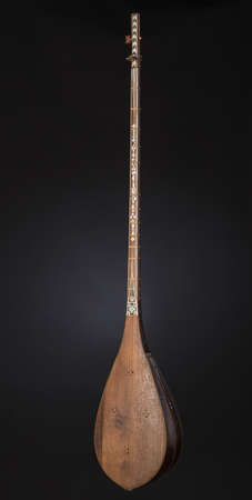 ancient Asian stringed musical instrument on black background with backlight