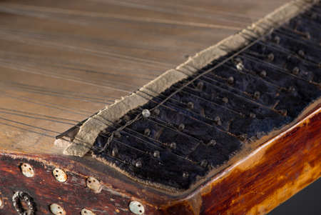 ancient Asian stringed musical instrument on black background with backlight. the similarity of the...