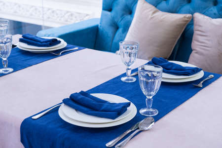serving banquet table in a luxurious restaurant in blue and light styleの写真素材