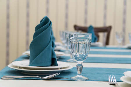serving banquet table in a luxurious restaurant in turquoise and white styleの写真素材