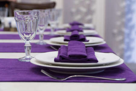serving banquet table in a luxurious restaurant in purple and white styleの写真素材