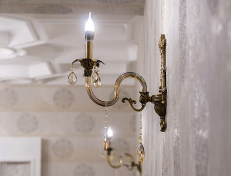 luxury wall lamp on the background of modeling and wallpaperの写真素材