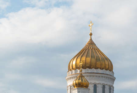 golden domes of the church with crosses against the skyの写真素材