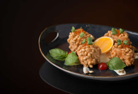 meat dish with nuts on a black background, isolatedの写真素材