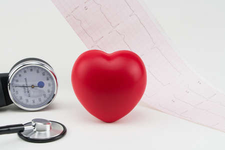 Toy heart and stethoscope on electrocardiogram background. Concept healthcare. Cardiology - care of the heartの写真素材