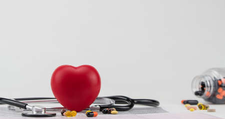 Stethoscope on electrocardiogram, and toy heart. Concept healthcare. Cardiology - care of the heartの写真素材