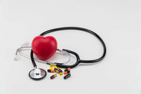 Stethoscope, pills and toy heart. Concept healthcare. Cardiology - care of the heartの写真素材