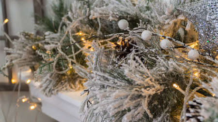 composition of Christmas decorations with fir tree and garlands. the sparkling lightsの写真素材