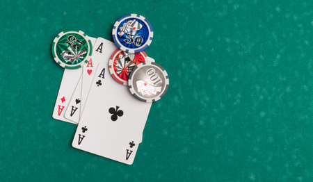 Poker chips and cards on a green background. The concept of gambling and entertainment. Casino and...