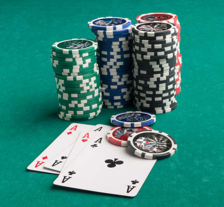 Poker chips and cards on a green background. The concept of gambling and entertainment. Casino and...