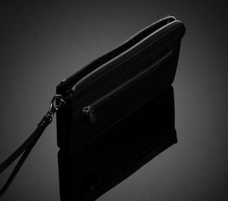 Fashionable leather men's wallet on a dark backgroundの写真素材