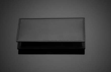 Fashionable leather men's wallet on a dark background
