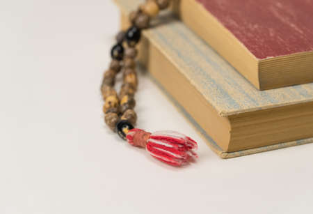 Muslim prayer beads and Quran isolated on a white background. Islamic and Muslim conceptsの写真素材