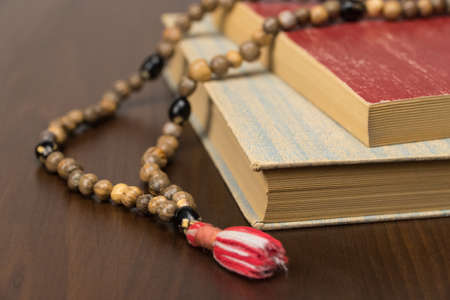 Muslim prayer beads and Koran isolated on a wooden background. Islamic and Muslim conceptsの写真素材