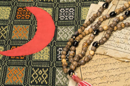 Muslim prayer beads with ancient pages from the Koran. Islamic and Muslim concepts. Ancient old...