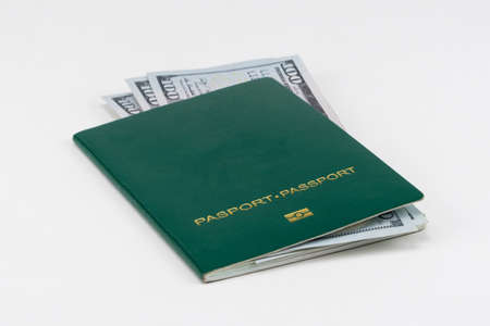 green passport with american dollars on white background, isolatedの写真素材