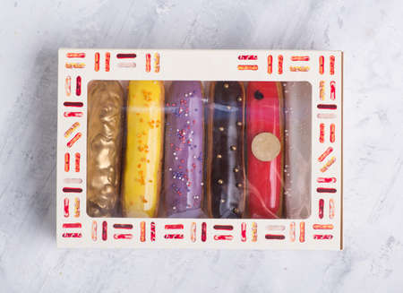 delicious cakes with icing in a gift box